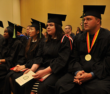 Graduates sit during