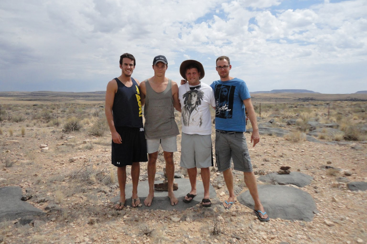 Four students stand in desert landscape