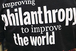 Tee shirt that says improving philanthropy to improve the world